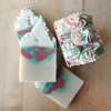 Handmade soaps with a red and green pattern. White soap frosting top, red and green glitter