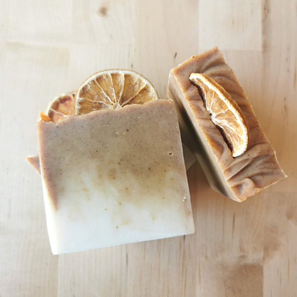 Handmade soaps with a dark orange and white colour. Each topped with a dried orange slice..