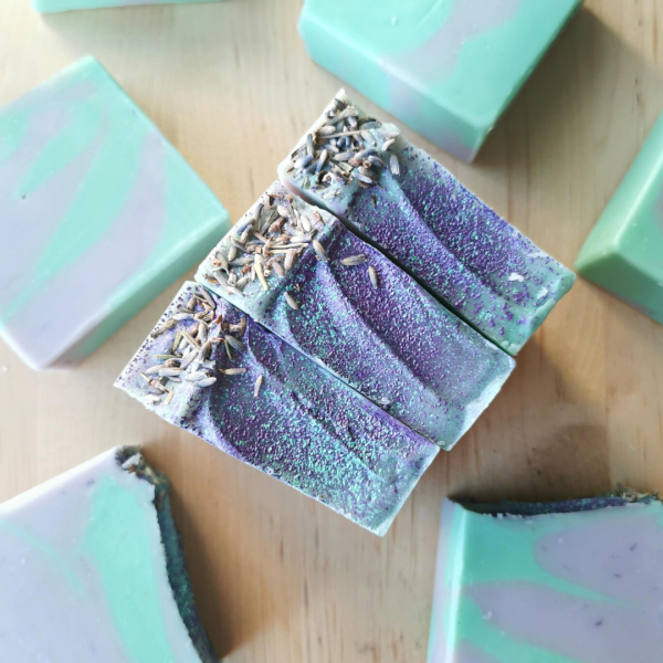 Teal and lavender handmade soaps with glittery tops and lavender buds